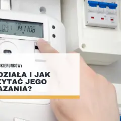 Dłoń wskazuje na licznik dwukierunkowy, pokazując jego odczyty. Dowiedz się, jak działa i jak odczytać wskazania licznika dwukierunkowego.